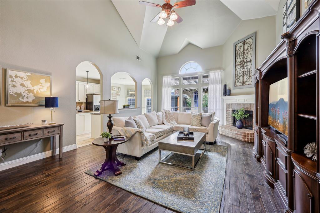 5603 Blazing Star Road Frisco, TX 75036 - Photo 6 of 39 a living room with furniture a fireplace and a flat screen tv