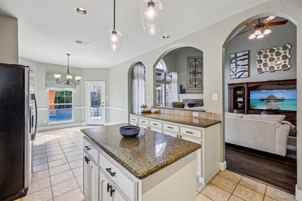 5603 Blazing Star Road Frisco, TX 75036 - Photo 10 of 39 a large kitchen with granite countertop a sink a counter top space and stainless steel appliances