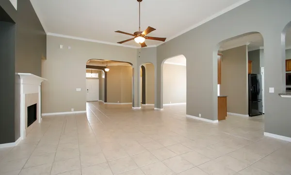 a view of a livingroom with a ceiling fan and window