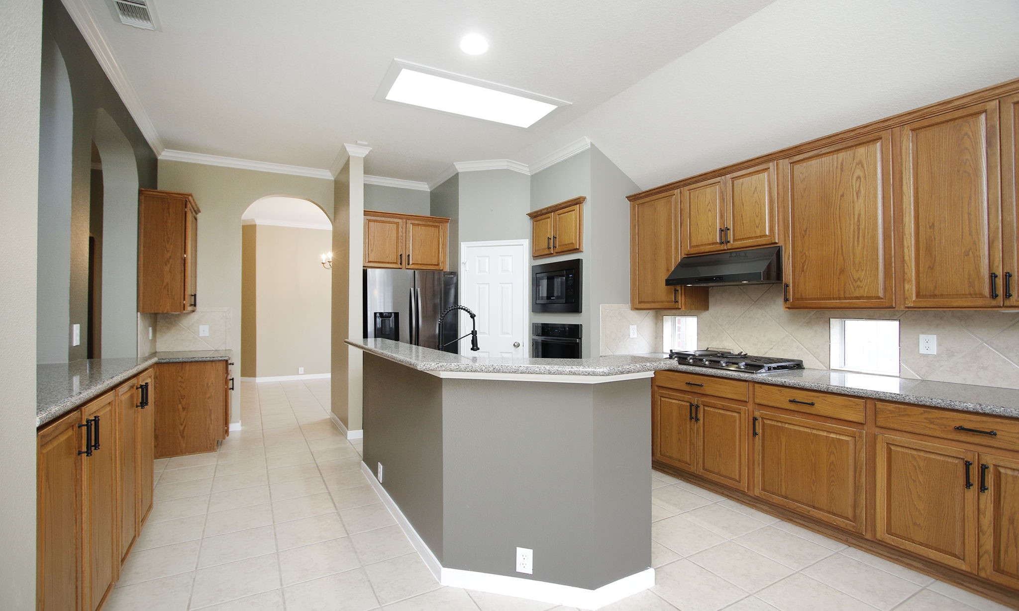 2802 Parkeston Drive Spring, TX 77388 - Photo 21 of 49 a kitchen with stainless steel appliances a sink stove and cabinets