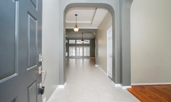 a view of a hallway with wooden floor and entryway