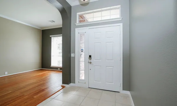 an empty room with windows and closet
