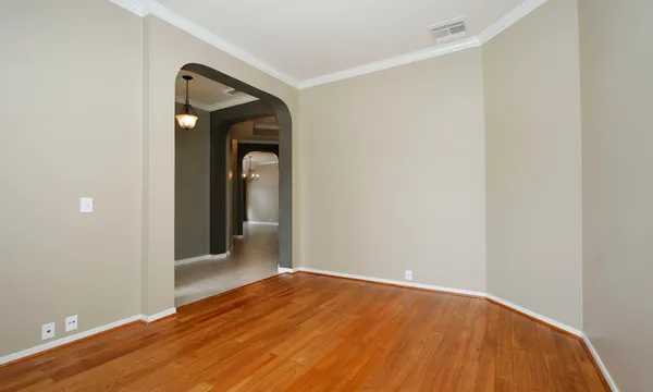 a view of a room with wooden floor and small entryway
