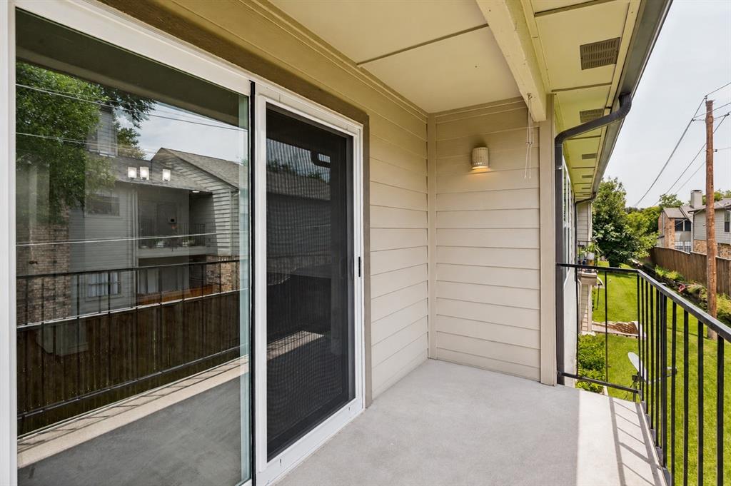 5300 Keller Springs Road, Unit 2042 Dallas, TX 75248 - Photo 25 of 28 Private balcony featuring a concrete floor, horizontal siding, and a black metal railing