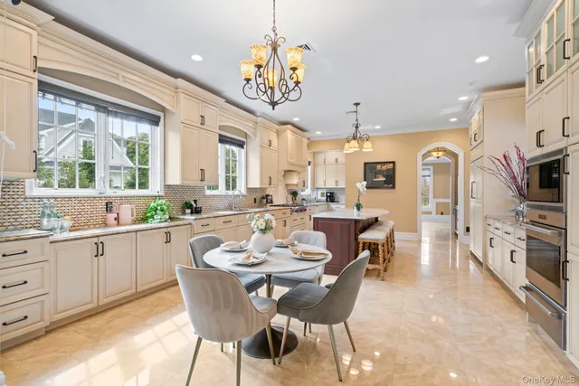 a large kitchen with a table and chairs in it