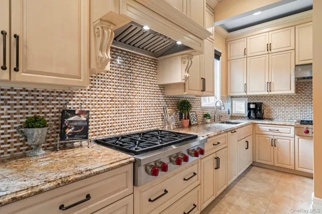 a kitchen with white cabinets and appliances