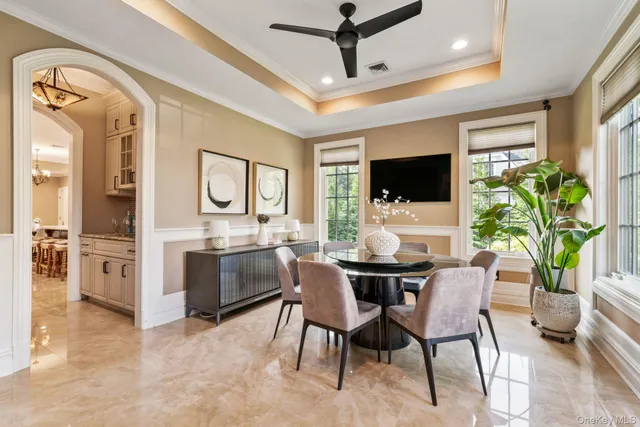 a living room with furniture a large window and a flat screen tv