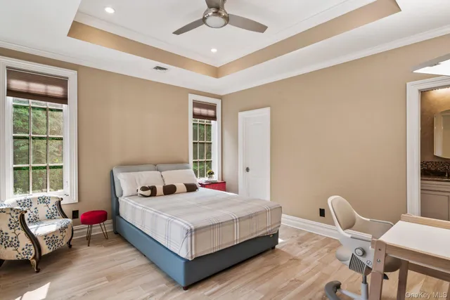 a bedroom with a bed wooden floor and furniture