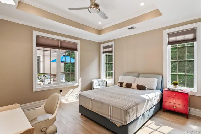 a bedroom with a bed and windows