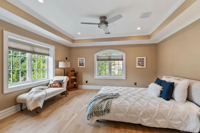 a bedroom with a bed and a large window