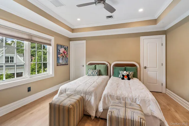 a bed sitting in a bedroom next to a window