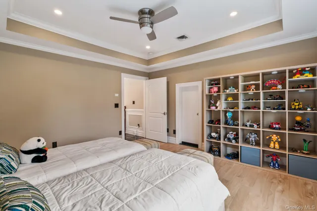 a bedroom with a large bed and a chandelier