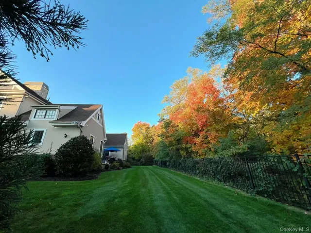 a view of a house with a yard and a garden
