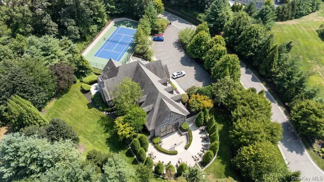 an aerial view of a house with a yard and trees