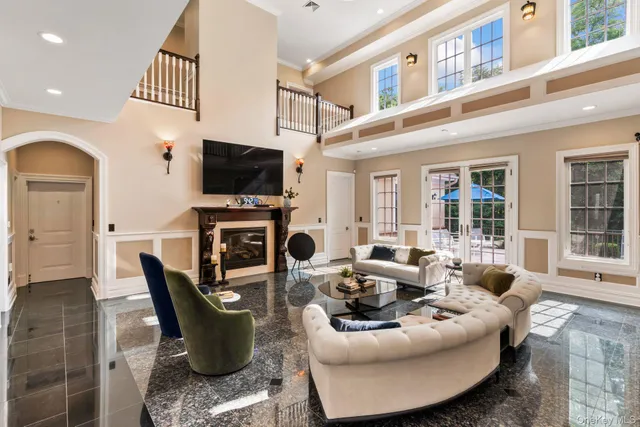 a living room with fireplace furniture and a flat screen tv