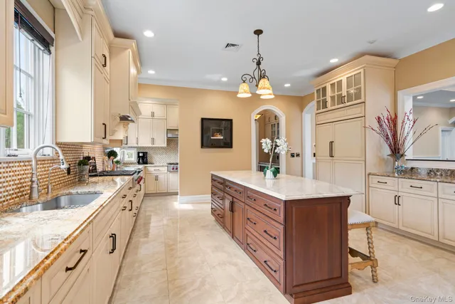 a large kitchen with stainless steel appliances a stove sink and cabinets