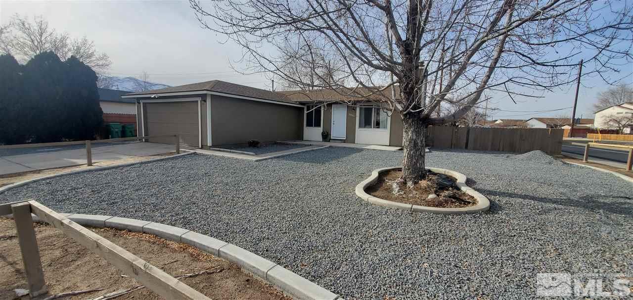 14095 Kernite Street Reno, NV 89506 - Photo 4 of 13 a front view of a house with a yard and garage