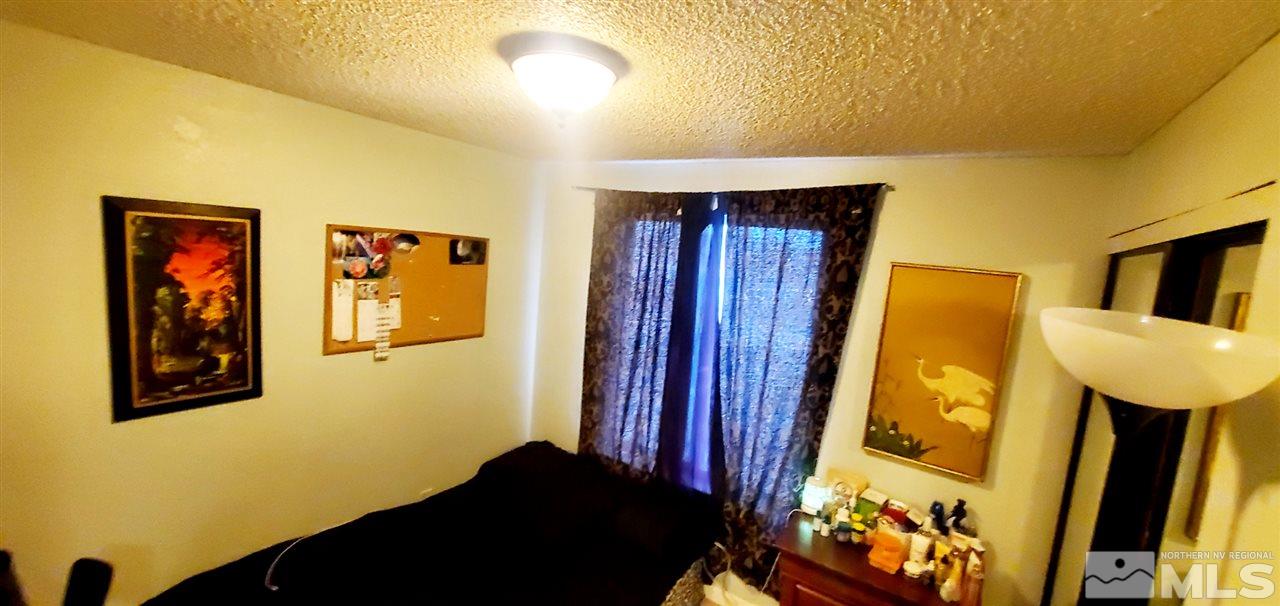 14095 Kernite Street Reno, NV 89506 - Photo 5 of 13 a bedroom with a bed and a dresser