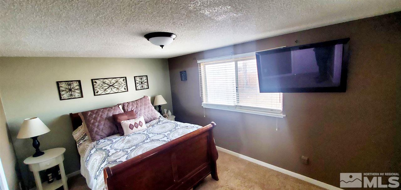 14095 Kernite Street Reno, NV 89506 - Photo 8 of 13 a bedroom with a bed and a window