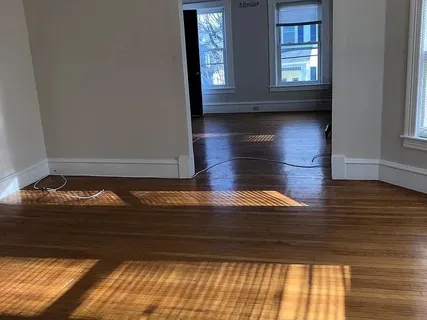 a view of room with window and wooden floor