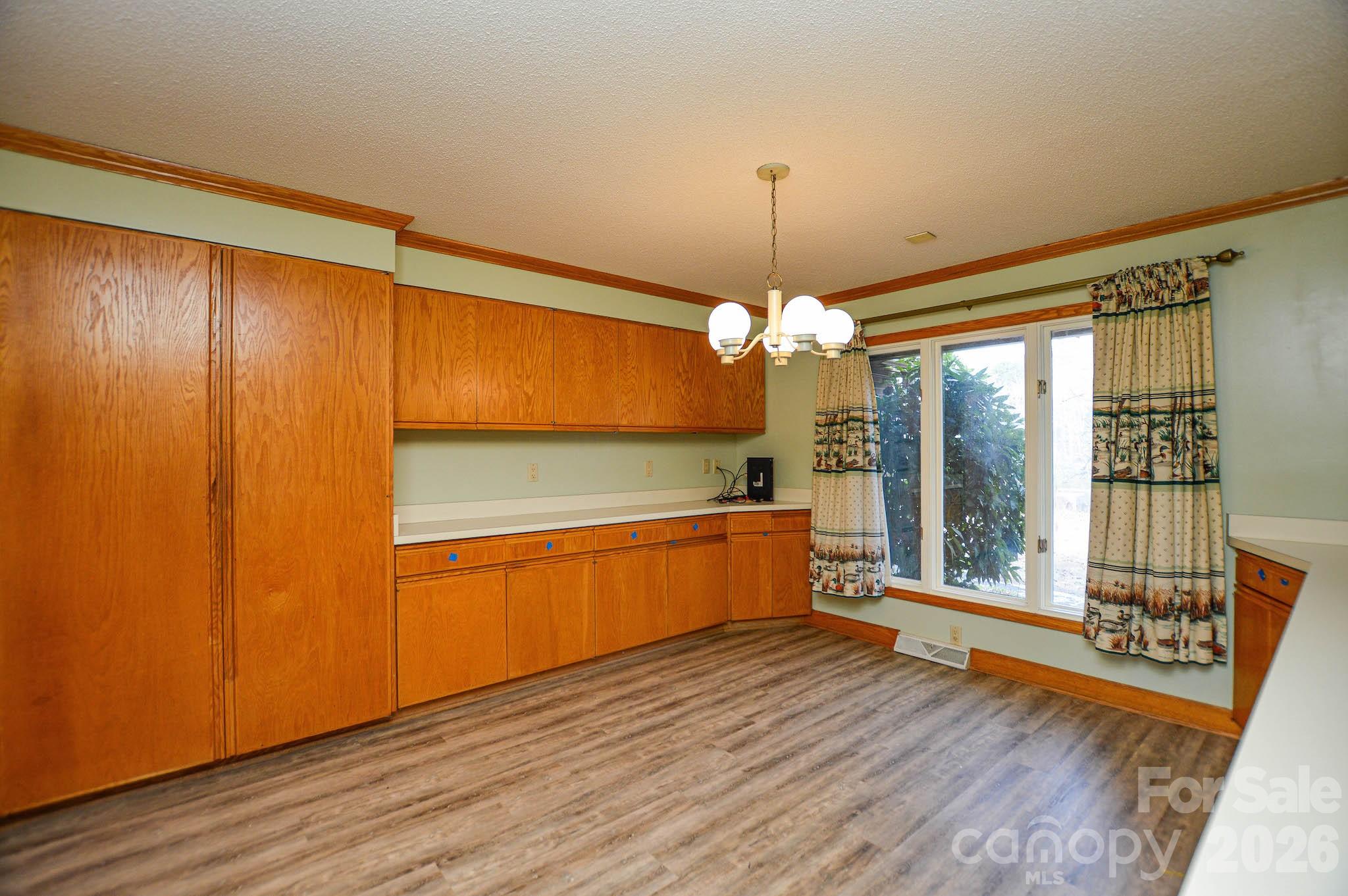 6910 State Highway 49 Mount Pleasant, NC 28124 - Photo 11 of 26 a large kitchen with a wooden floor and outdoor space