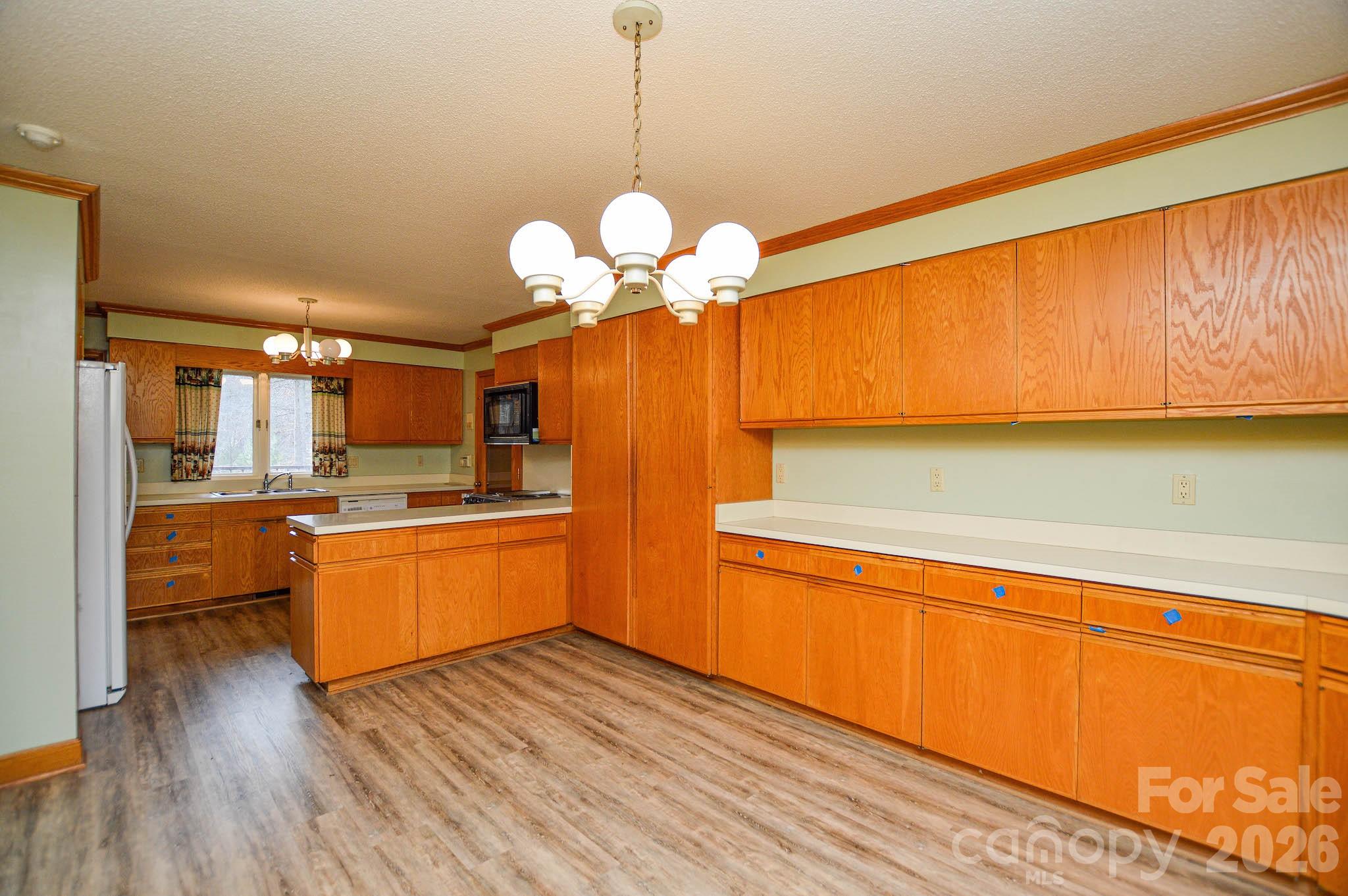 6910 State Highway 49 Mount Pleasant, NC 28124 - Photo 10 of 26 a large kitchen with chandelier in it