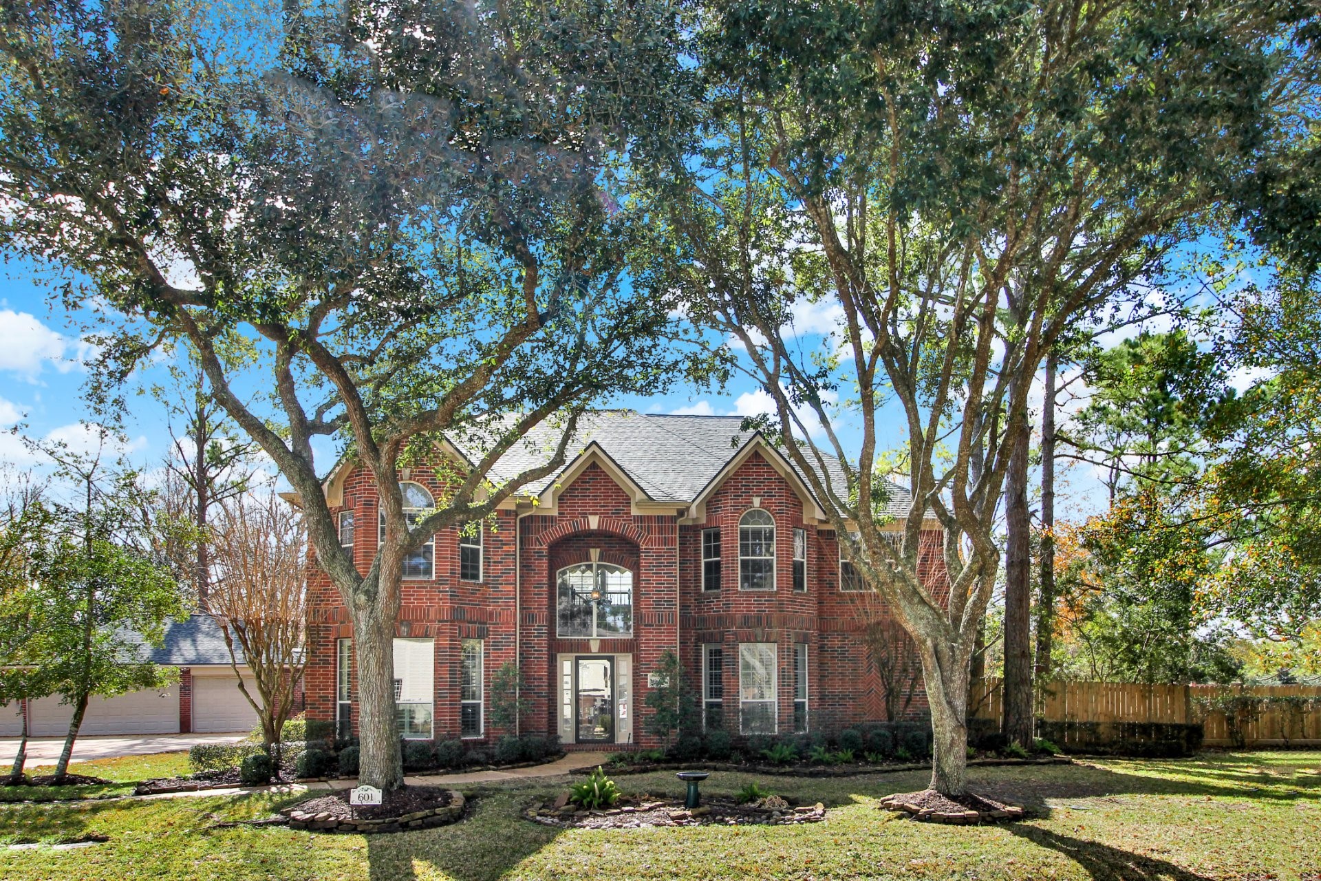 601 Forest Bend Lane Friendswood, TX 77546 - Photo 1 of 27 a front view of a residential apartment building with trees