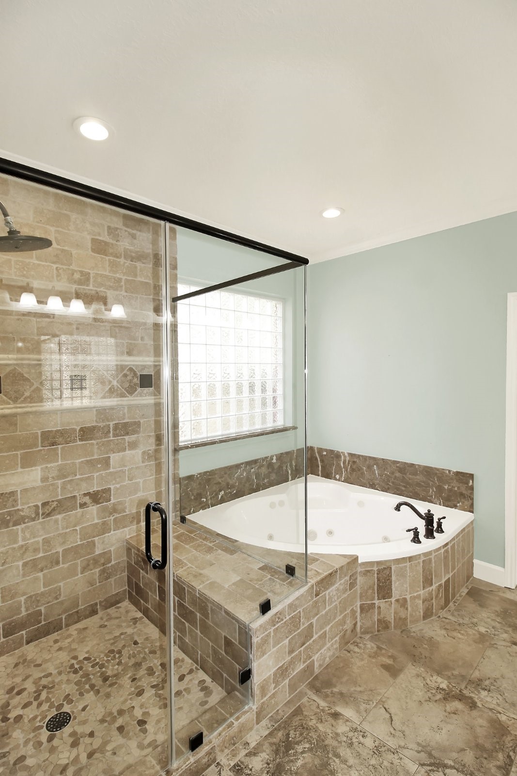 601 Forest Bend Lane Friendswood, TX 77546 - Photo 12 of 27 a bathroom with a tub and a shower