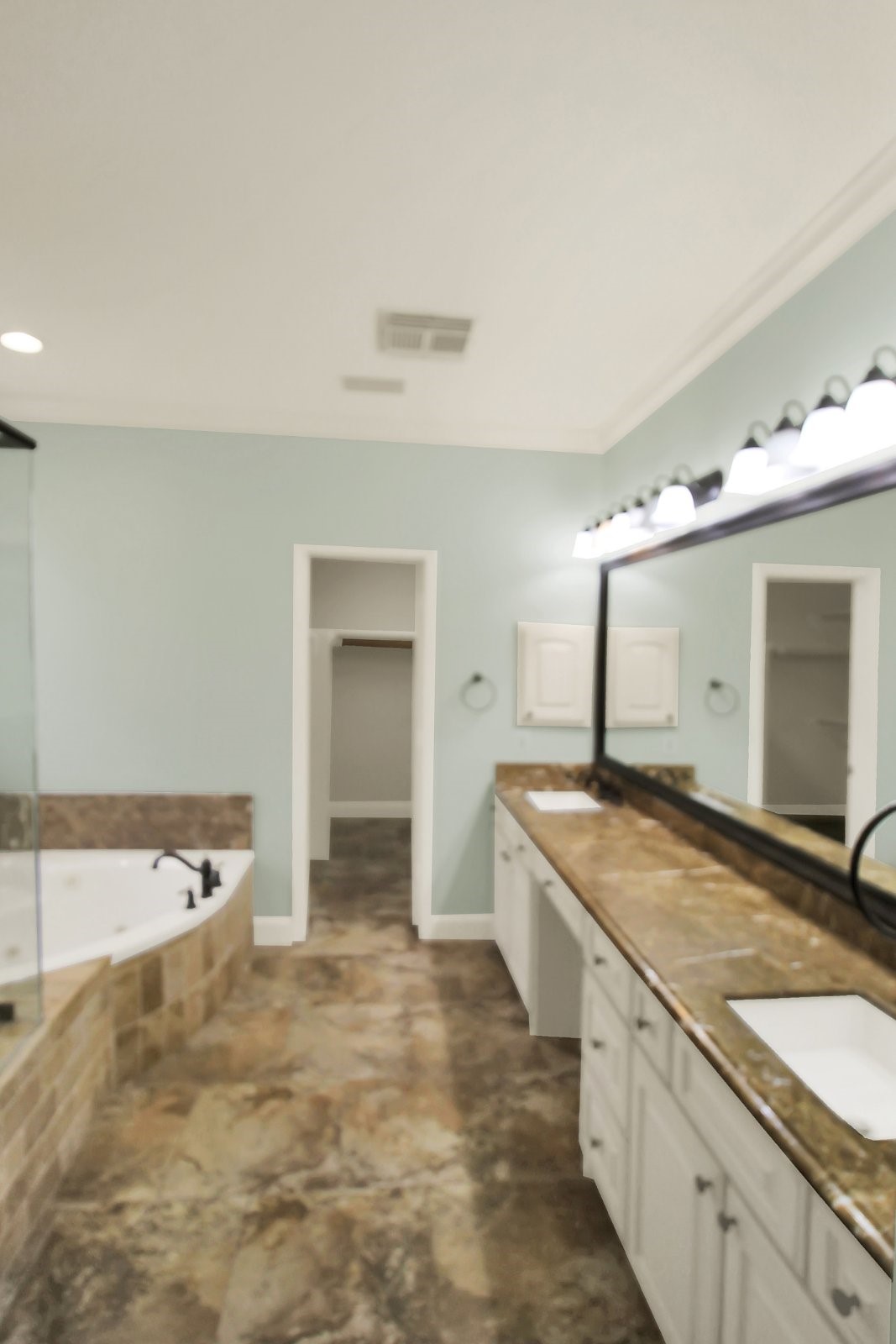 601 Forest Bend Lane Friendswood, TX 77546 - Photo 13 of 27 a spacious bathroom with a granite countertop sink and a mirror