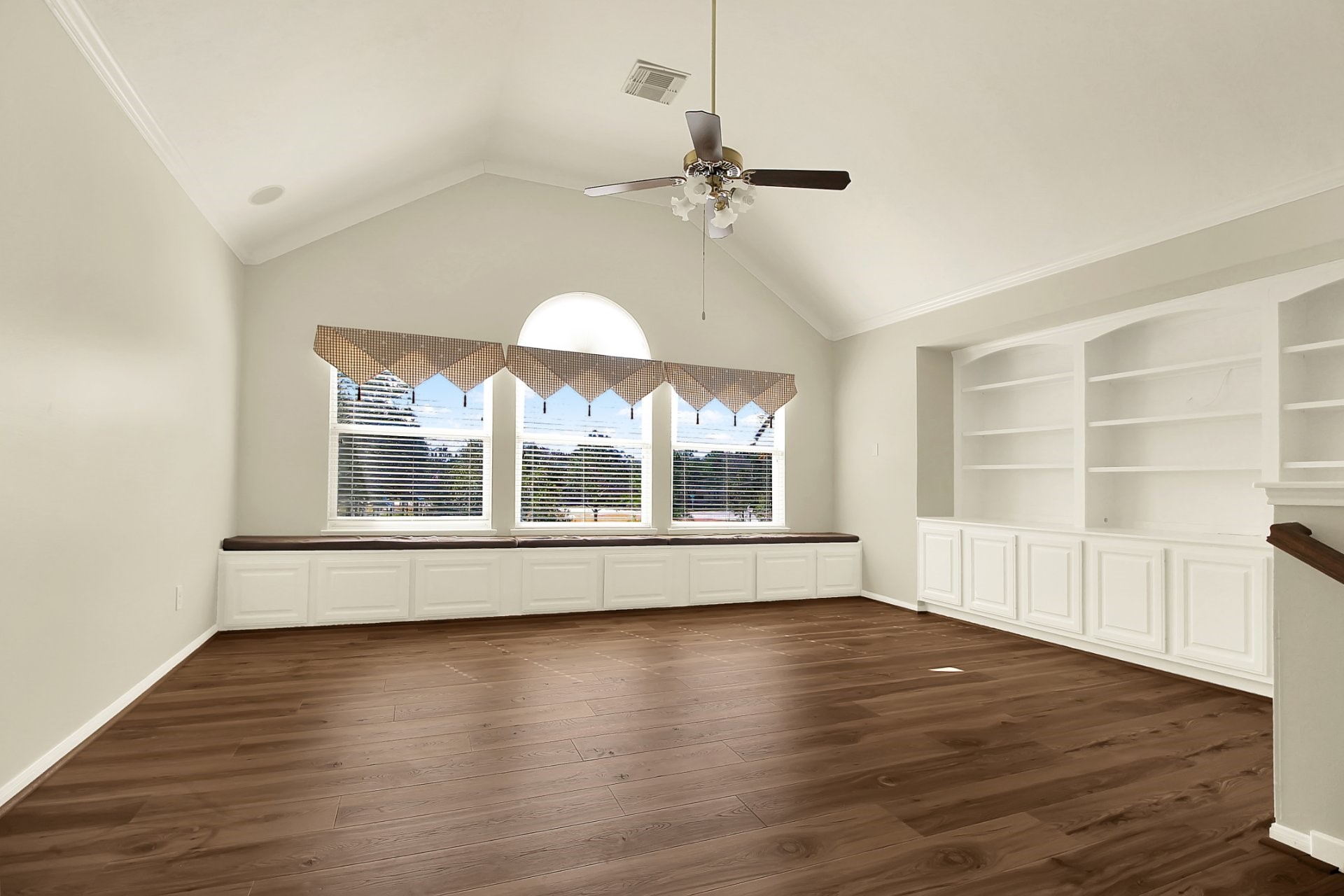 601 Forest Bend Lane Friendswood, TX 77546 - Photo 15 of 27 an empty room with wooden floor chandelier and windows