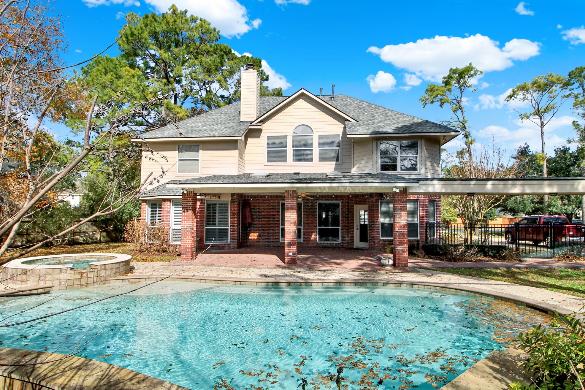 601 Forest Bend Lane Friendswood, TX 77546 - Photo 26 of 27 a front view of a building with lots of trees and plants