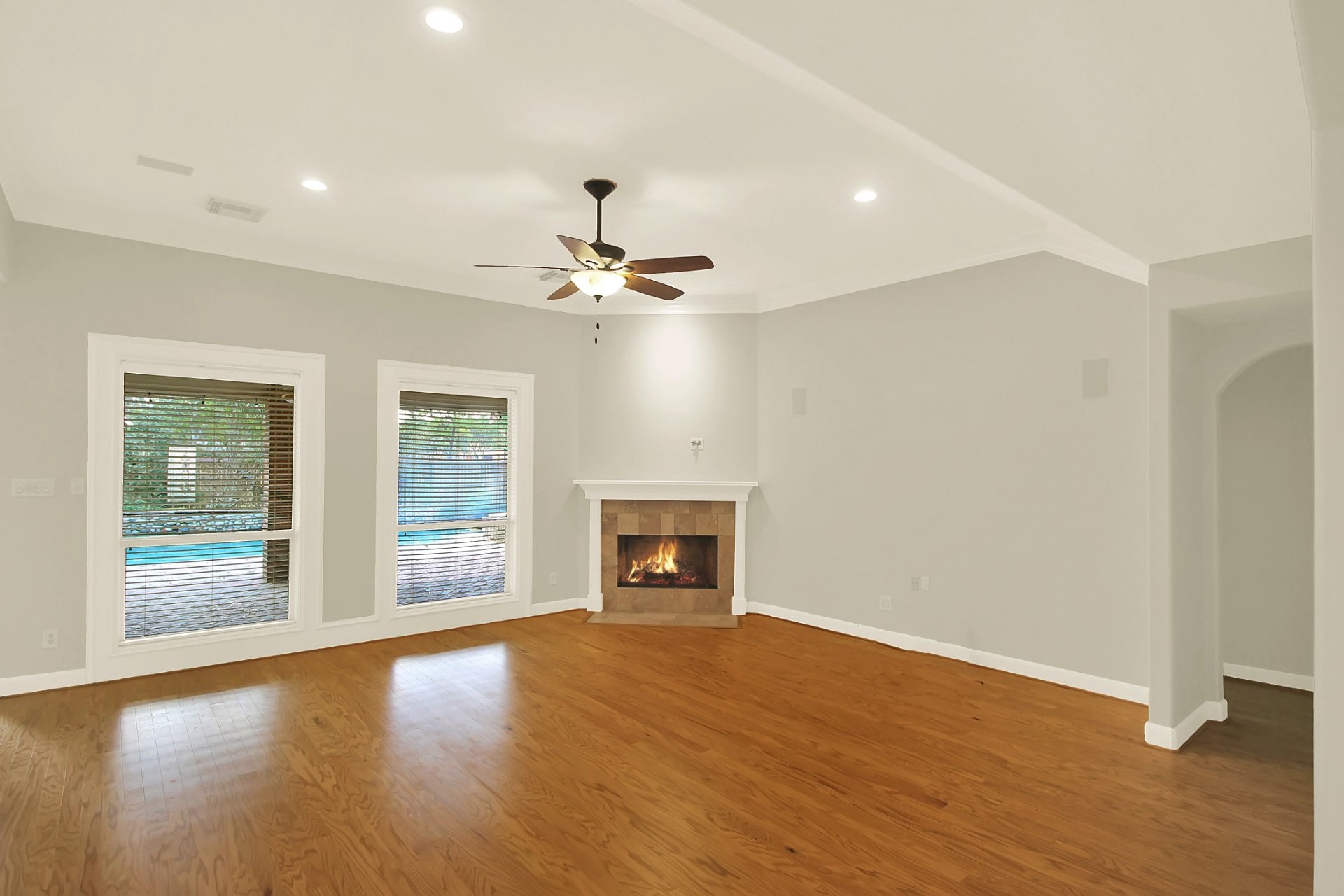 601 Forest Bend Lane Friendswood, TX 77546 - Photo 8 of 27 a view of an empty room with wooden floor fireplace and a window