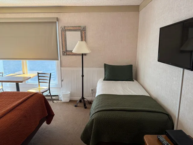 a bedroom with a bed and a lamp