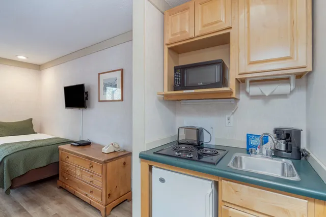 a kitchen with stainless steel appliances granite countertop a sink stove and microwave