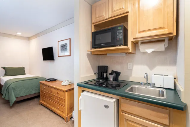 a kitchen with stainless steel appliances granite countertop a sink and a microwave