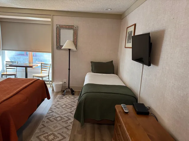 a bedroom with a bed and flat screen tv