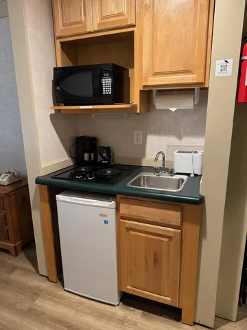 a kitchen with granite countertop white cabinets and a stove