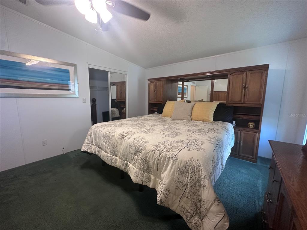 1100 South Belcher Road, Unit 406 Largo, FL 33771 - Photo 11 of 46 a bed sitting in a bedroom next to a window