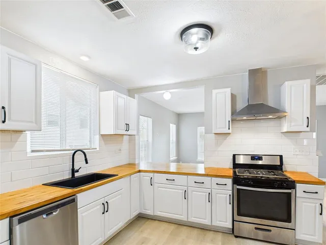 a kitchen with stainless steel appliances granite countertop a sink and cabinets