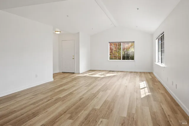 a view of a living room with wooden floor