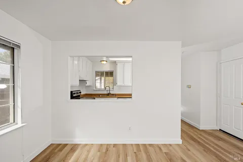 a kitchen with granite countertop a sink and cabinets