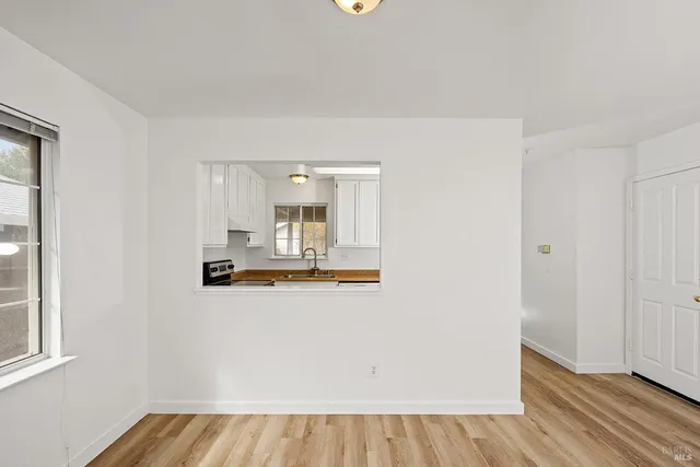 a kitchen with granite countertop a sink and cabinets