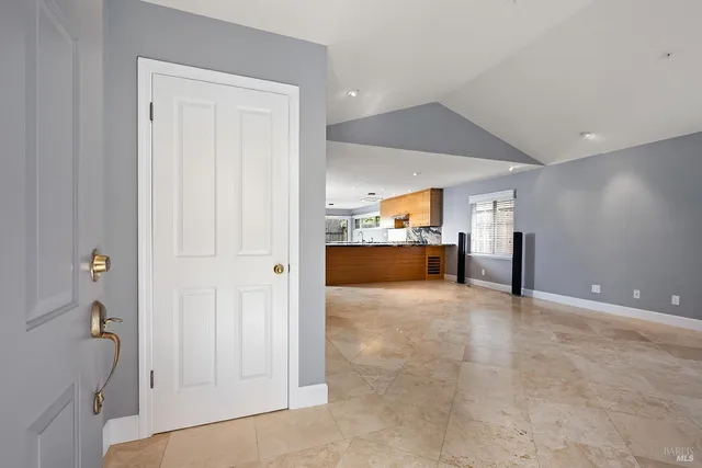 an empty room with a cabinet and mirrors