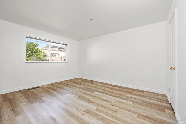 a view of a house with a wooden fence