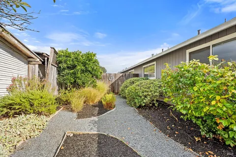 a front view of house with a garden