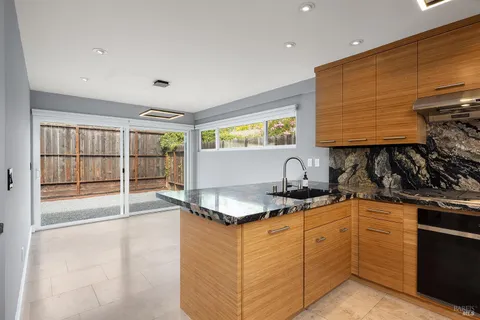 a kitchen with white cabinets a sink and a stove
