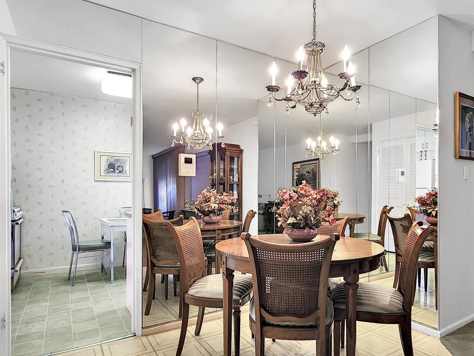 140-21 31st Road, Unit 4A Queens, NY 11354 - Photo 2 of 7 a view of a dining room with furniture and chandelier