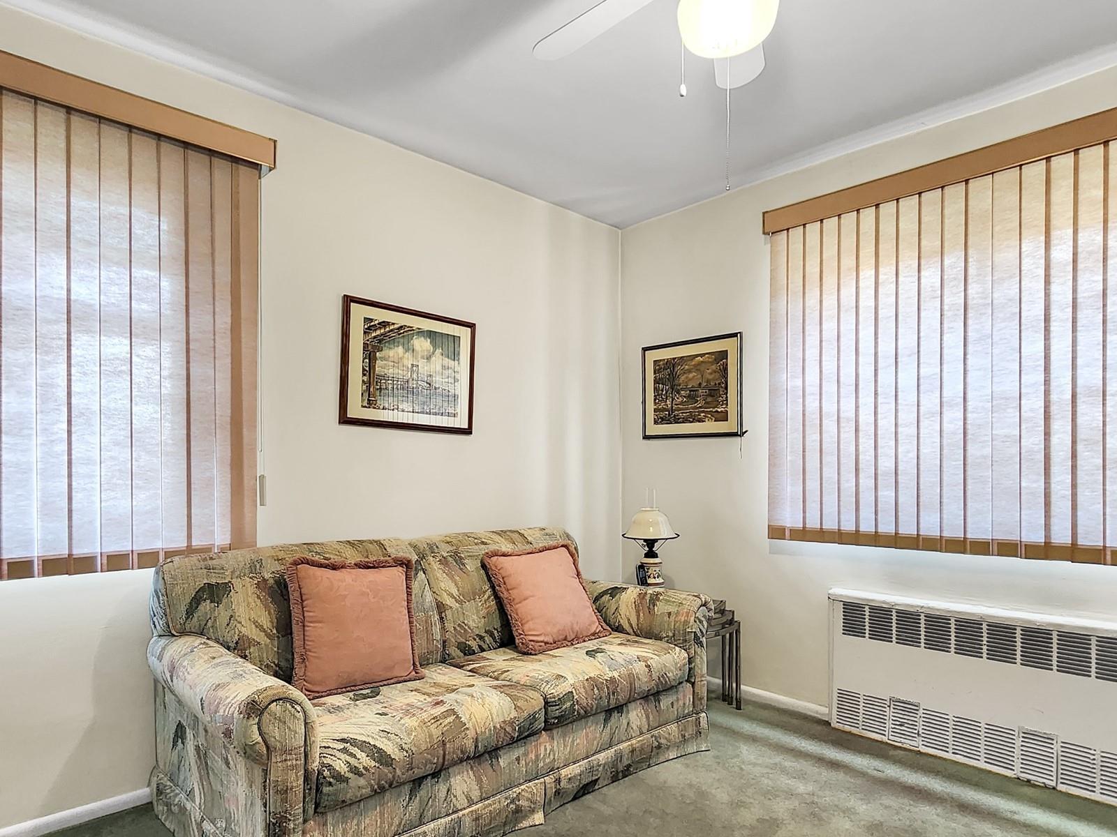 140-21 31st Road, Unit 4A Queens, NY 11354 - Photo 6 of 7 a living room with a couch and a window