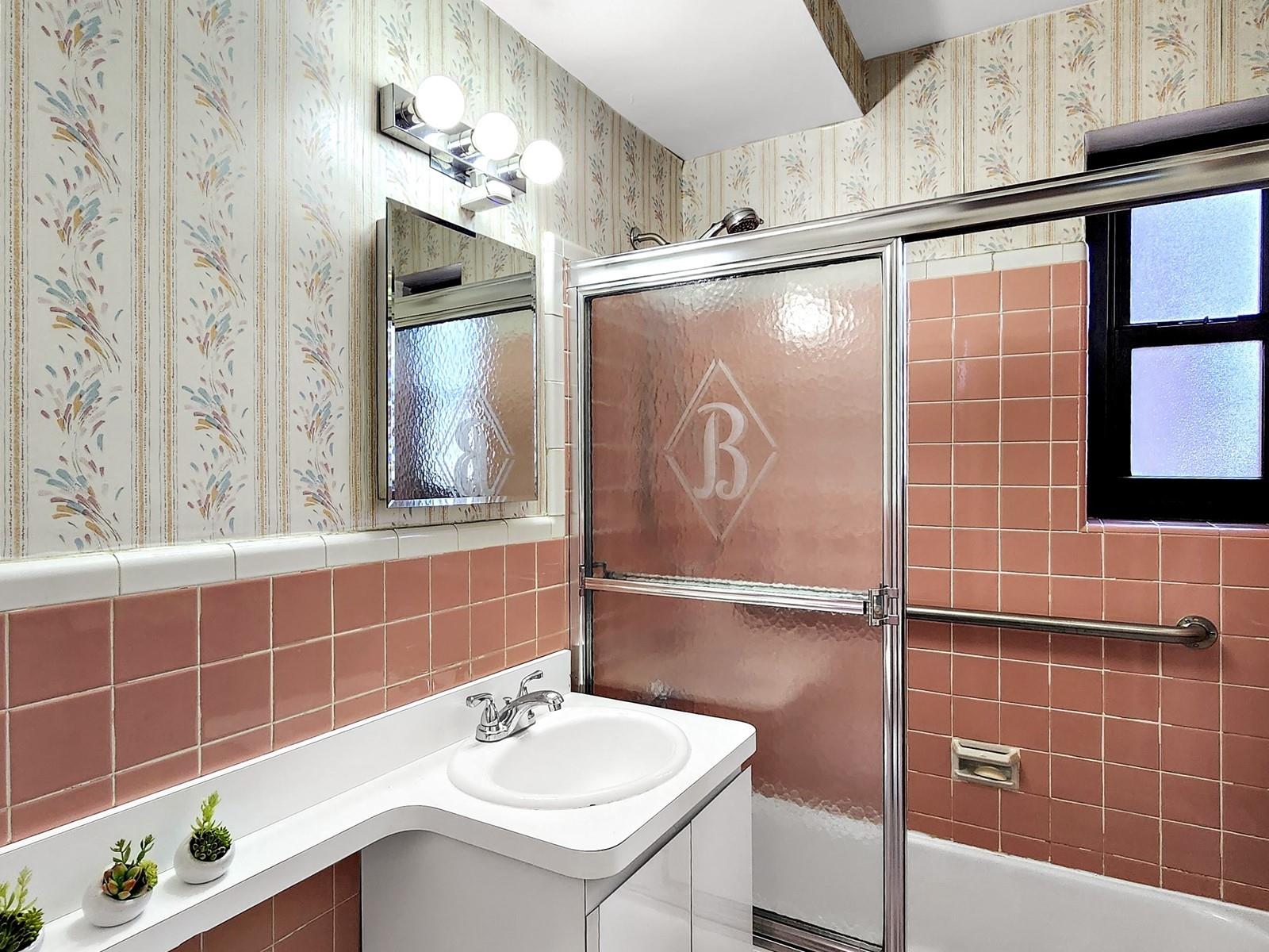 140-21 31st Road, Unit 4A Queens, NY 11354 - Photo 7 of 7 a bathroom with a sink and a mirror