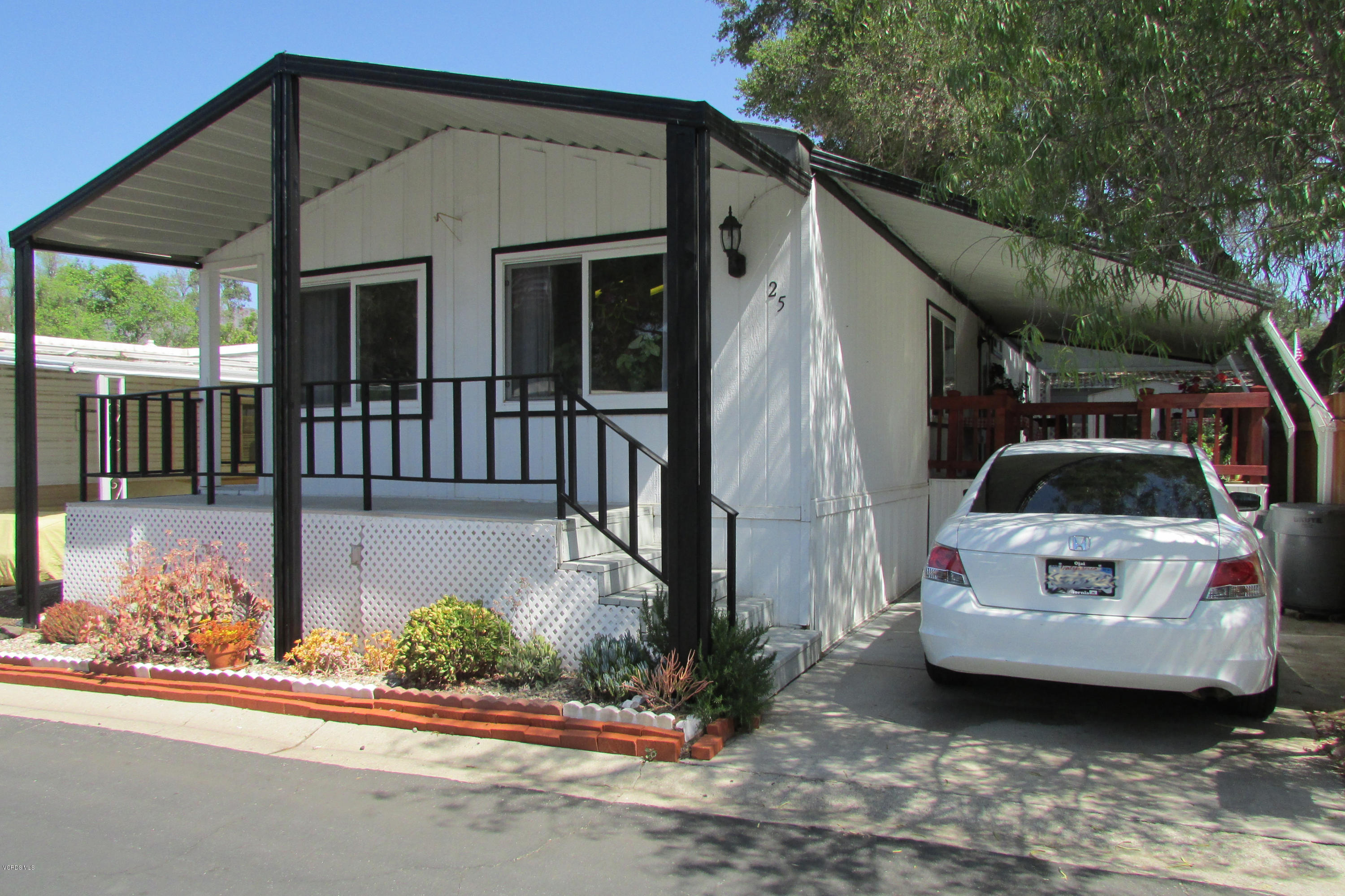 1225 South Rice Road, Unit 25 Ojai, CA 93023 - Photo 7 of 35 a white house that has a tree in front of it